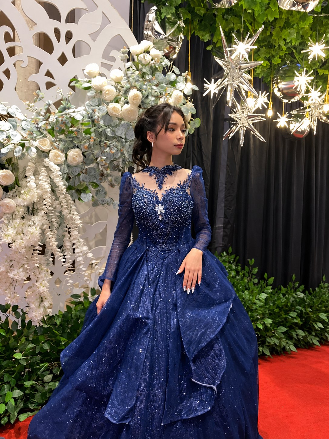 Kylie in her blue debut gown among flowers